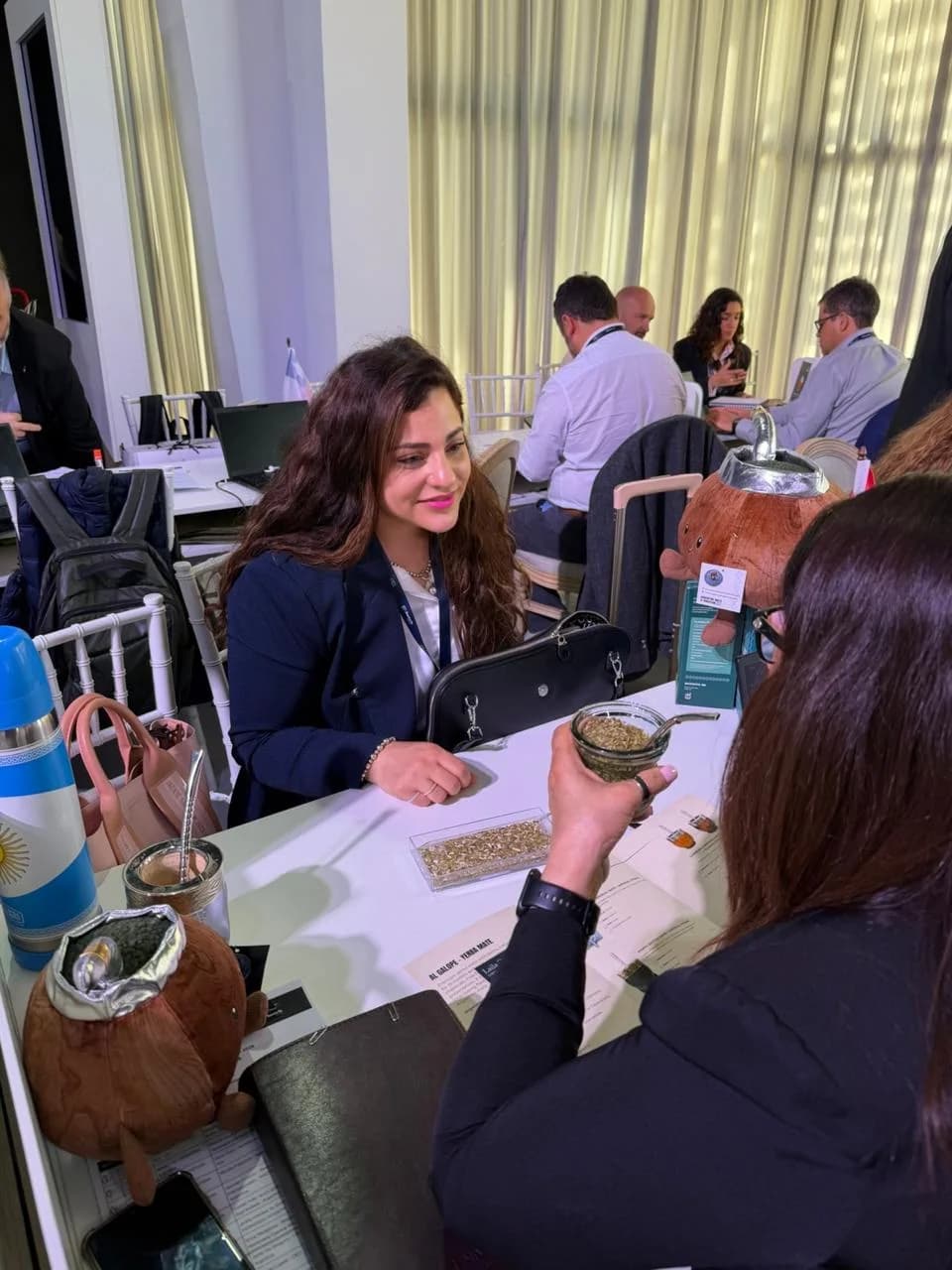 Laila sharing Al Galope yerba mate at the Santa Fe Business Forum